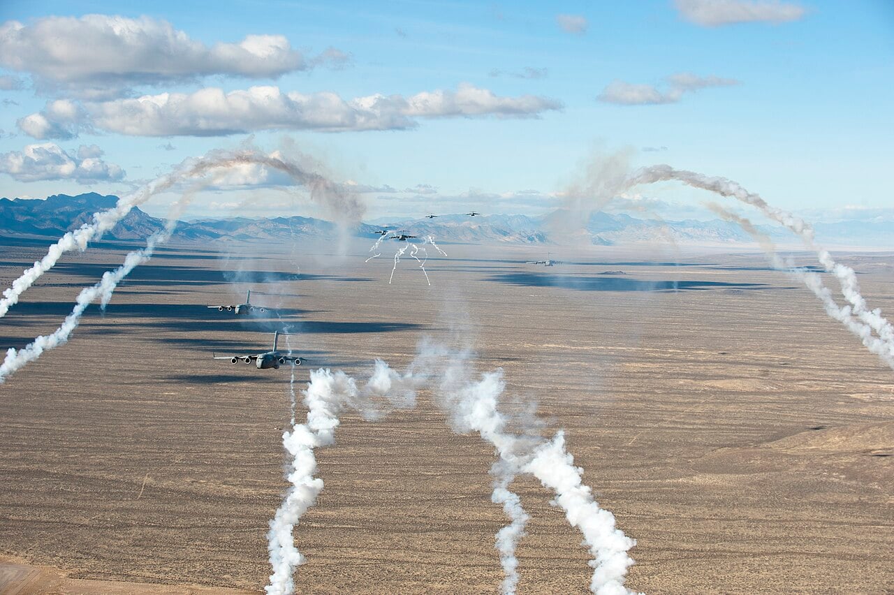 US Air Force C-17 Globemaster III transports deploying flares over the Nevada desert