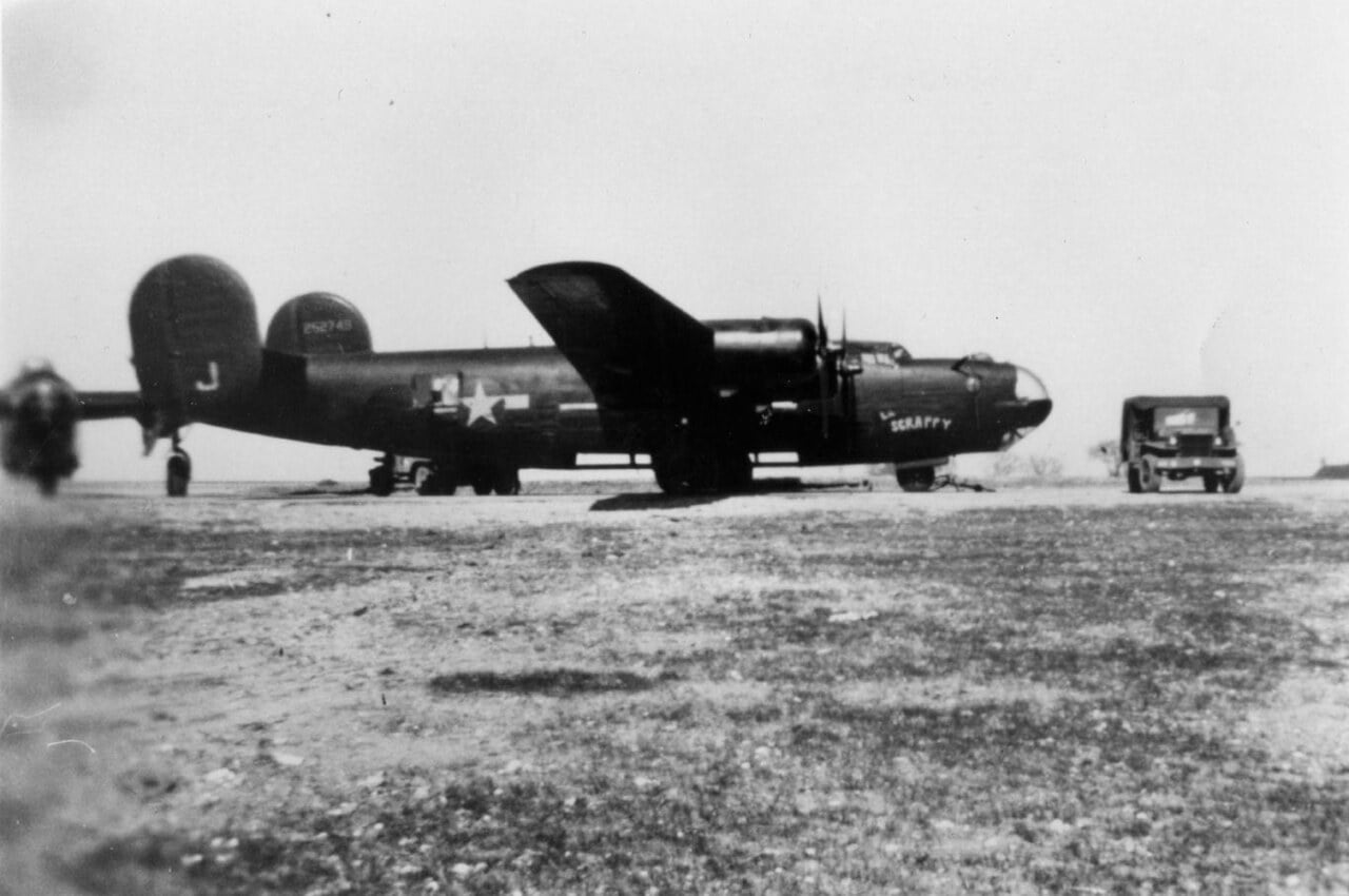 Black-painted B-24H Liberator Scrappy of the 492nd Bomb Group parked on a grass dispersal at Harrington