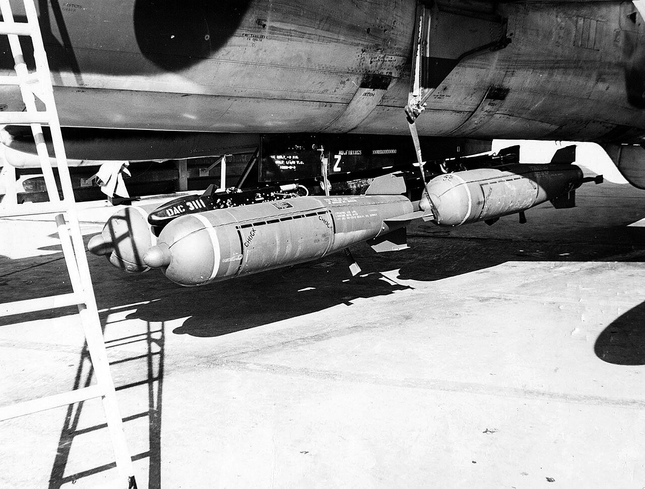 CBU-24 cluster bombs loaded under an F-105 Wild Weasel on the ramp