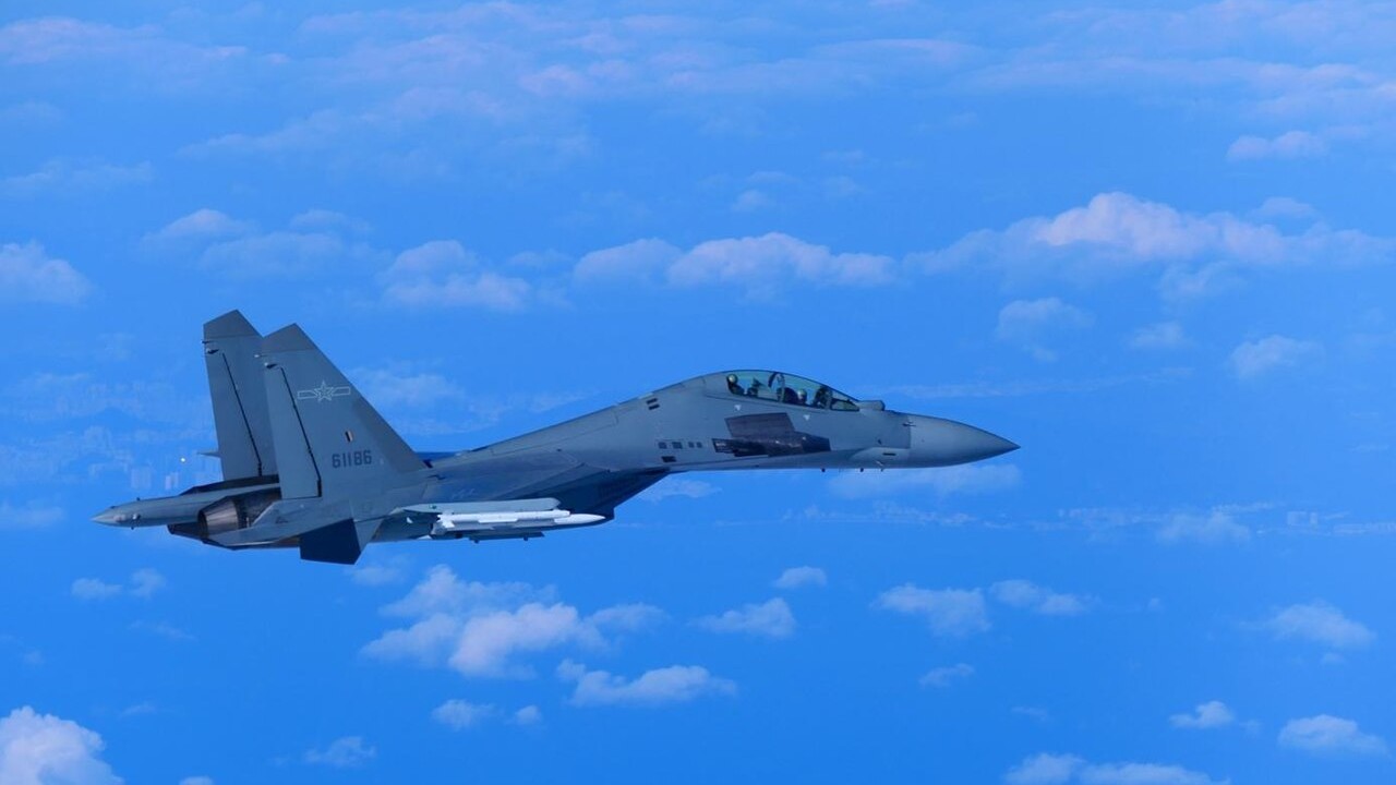 A Chinese PLA Air Force J-16 fighter carrying missiles over the sea