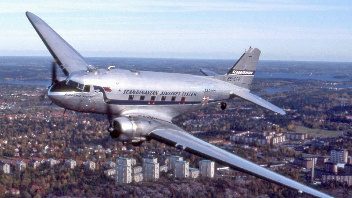 Douglas DC-3 in vintage Scandinavian Airlines colours flying over Lidingo, Sweden