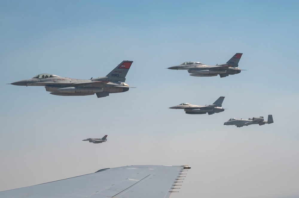 Egyptian Air Force F-16s and US Air Force jets fly in formation off the wing of a KC-10 Extender during Bright Star 23