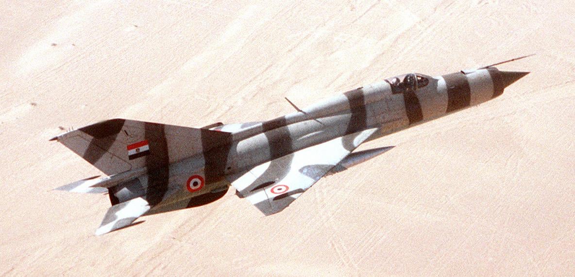Egyptian Air Force MiG-21 in camouflage flying over the desert