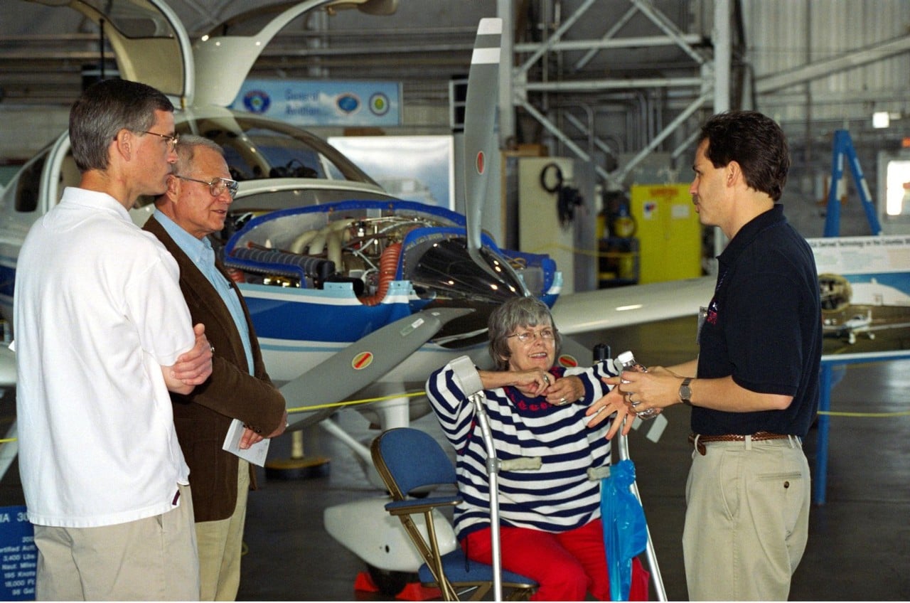 Elinor Smith, aged 89, seated in front of an experimental Beech Bonanza aircraft at NASA Langley talking with NASA staff