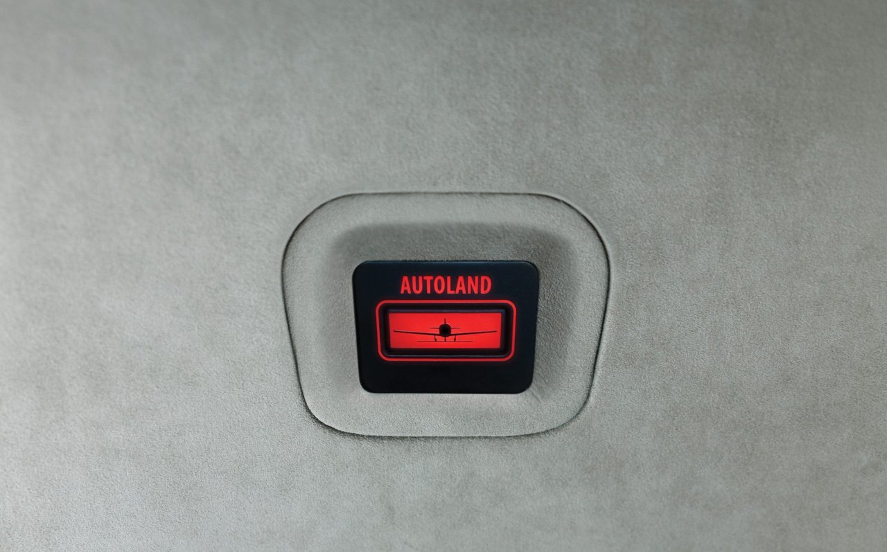 Illuminated red Autoland activation button set into the interior trim of an Epic E1000 AX
