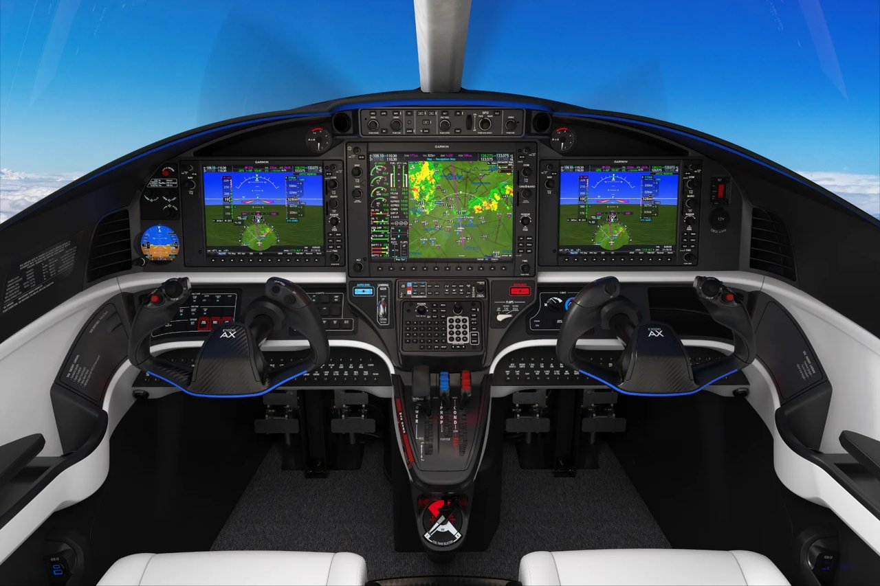 Epic E1000 AX cockpit with three Garmin G1000 NXi displays and a red Autoland button above the flap lever