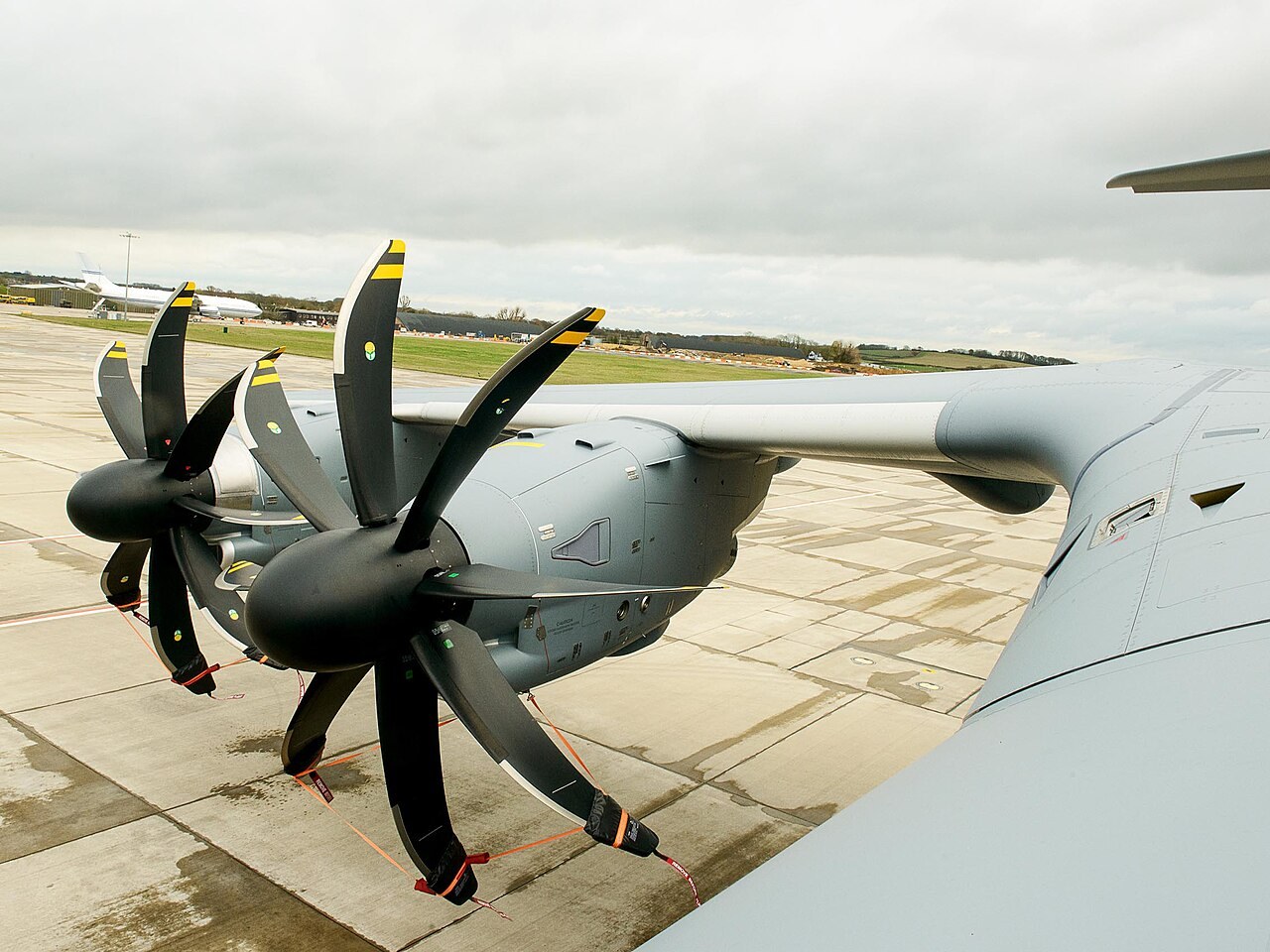 Two Europrop TP400 turboprop engines with eight-bladed propellers under the wing of the first Royal Air Force Airbus A400M Atlas at RAF Brize Norton