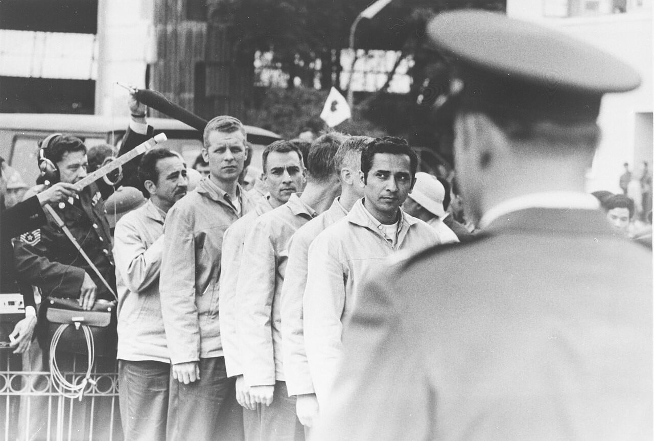American prisoners of war in light jackets lined up at Gia Lam Airport, Hanoi, awaiting release in February 1973