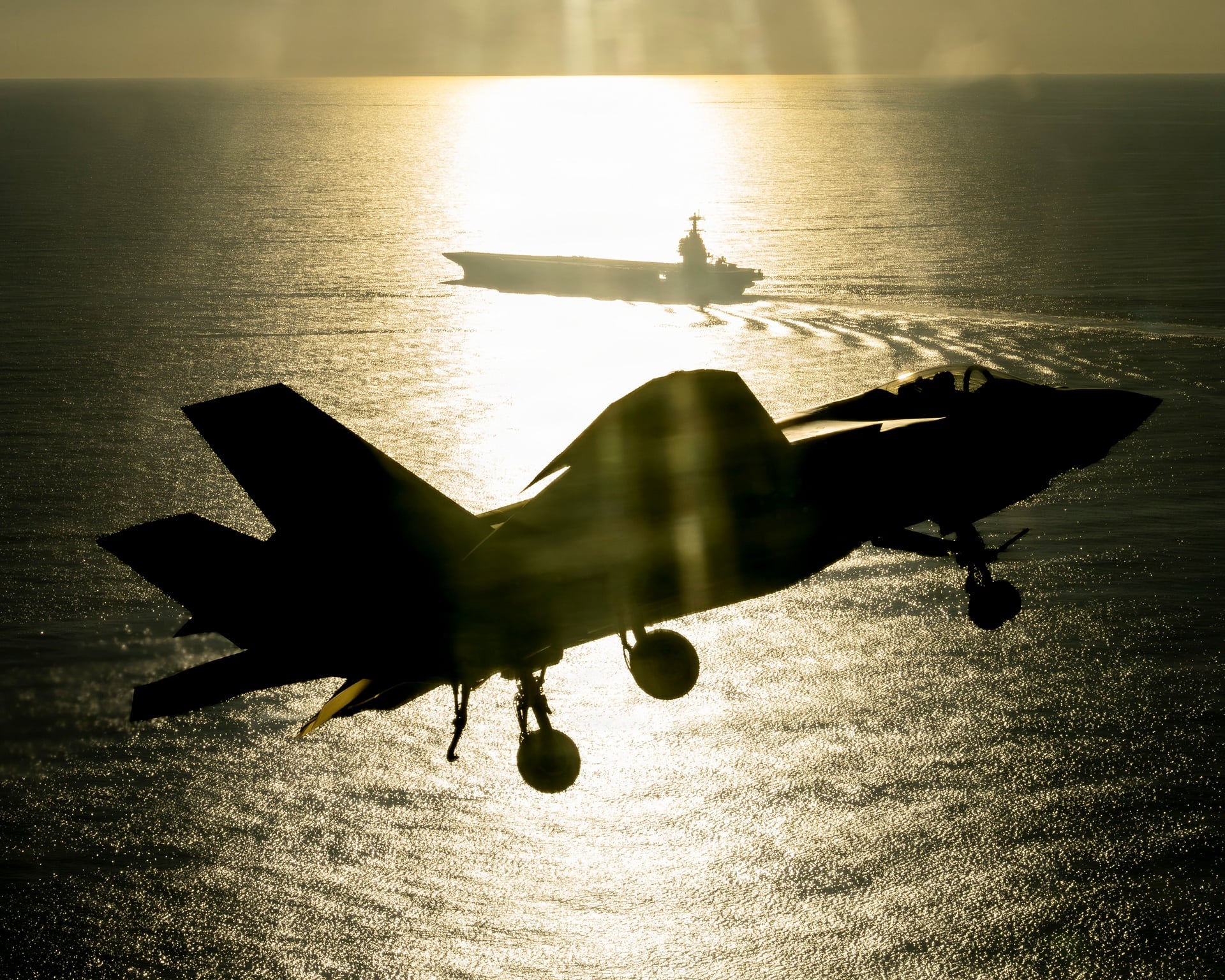 F-35C approaching the future USS John F. Kennedy at sunset