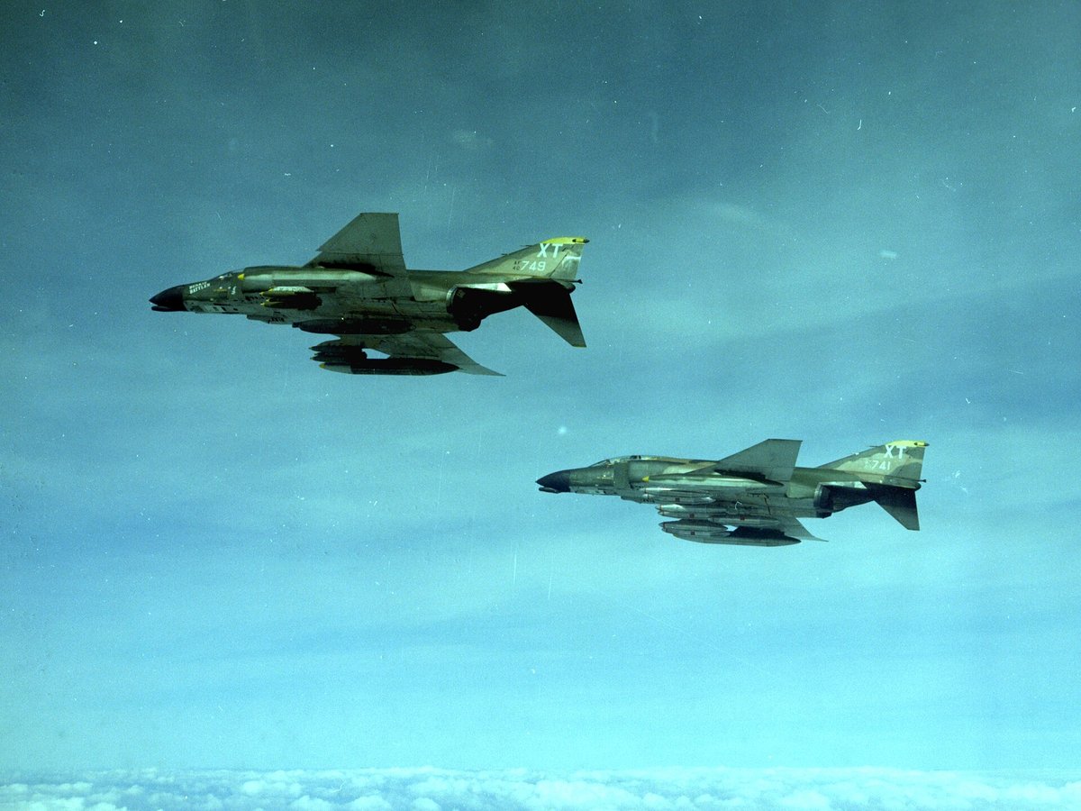 Two F-4C Phantom IIs of the 558th Tactical Fighter Squadron over South Vietnam in December 1968, one carrying a SUU-16 gun pod
