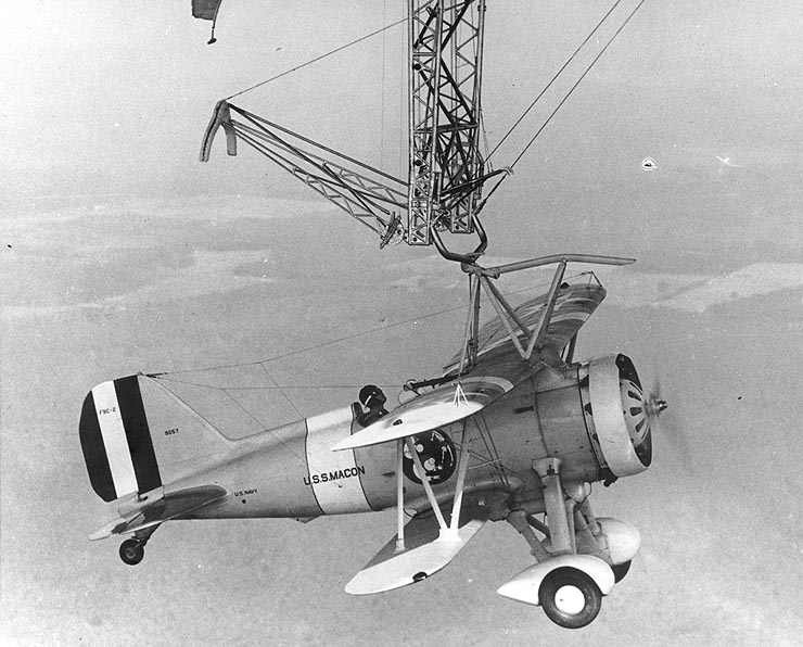 An F9C-2 Sparrowhawk fighter hanging from the trapeze of the airship USS Macon in 1933