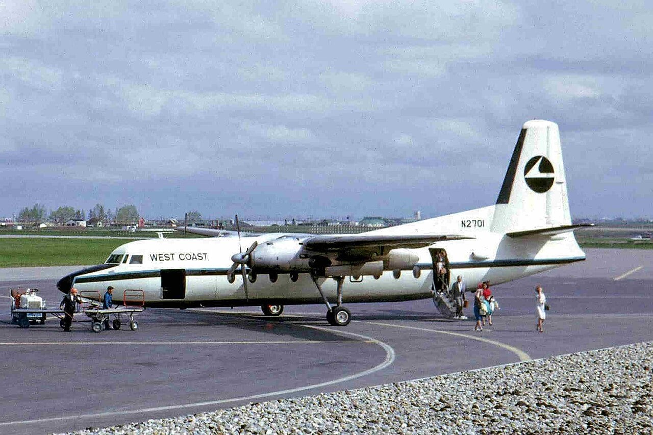 Fairchild F-27 N2701 in West Coast Airlines livery with passengers leaving through the rear airstair door