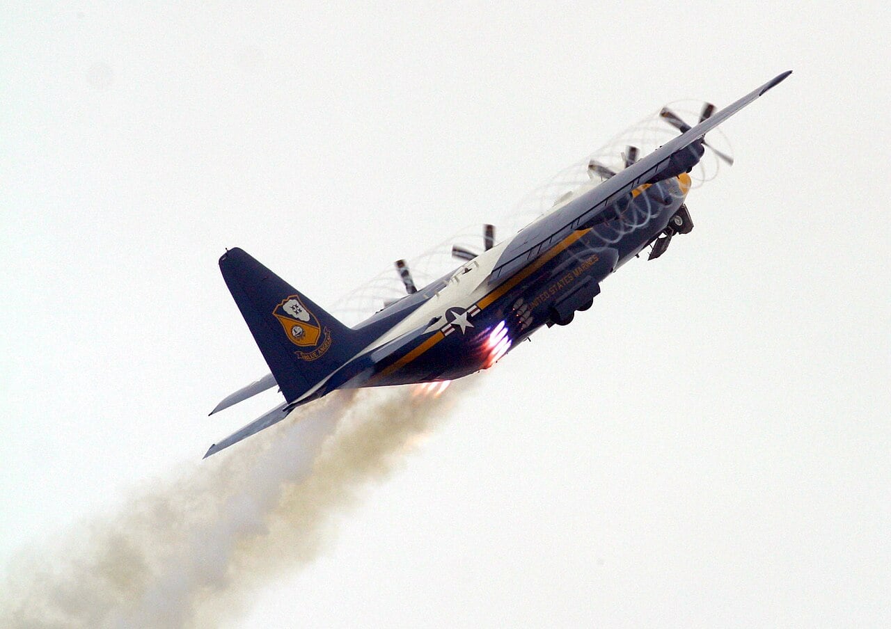 Blue Angels C-130T Fat Albert climbing steeply with JATO bottles firing