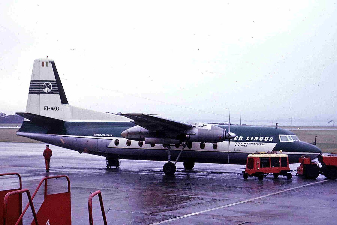 Aer Lingus Fokker F27-100 Friendship EI-AKG at Liverpool, 1964 Aer Lingus Fokker F27-100 Friendship EI-AKG in green and white livery on a wet apron at Liverpool in October 1964