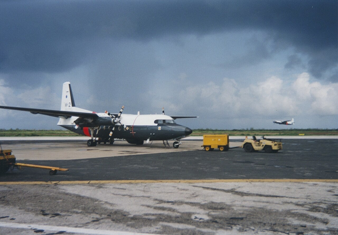 Royal Netherlands Air Force Fokker F27 Maritime M-2 of 336 Squadron on the apron at Curacao with sister aircraft M-1 taking off
