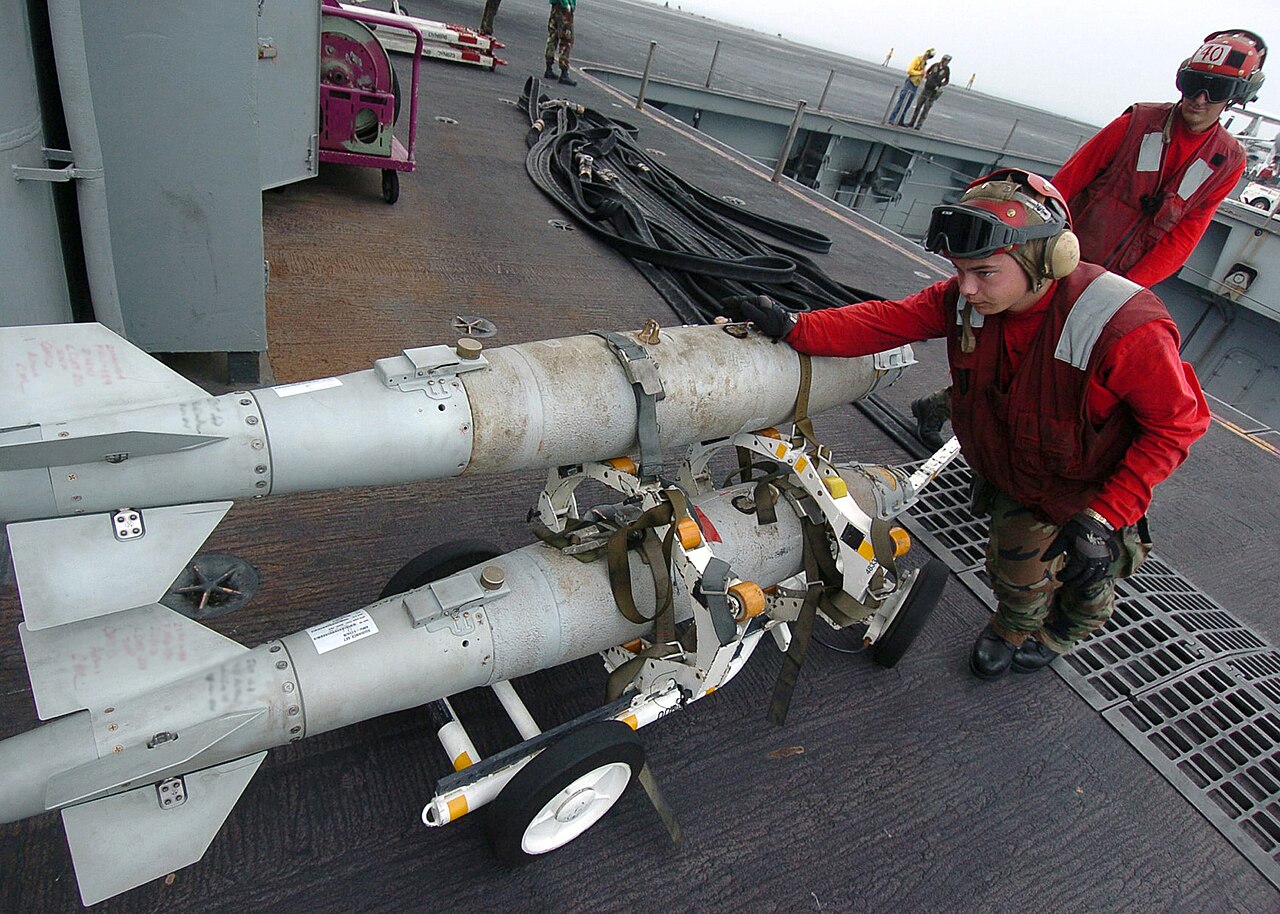 GBU-38 JDAM bombs being moved on a carrier deck