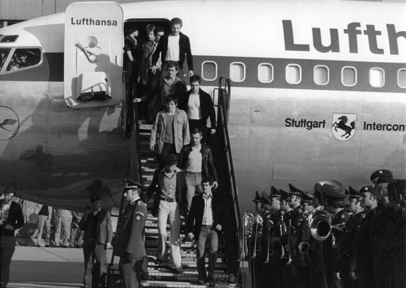 GSG 9 officers descend the steps of the Lufthansa Boeing 707 Stuttgart at Cologne/Bonn airport on 18 October 1977