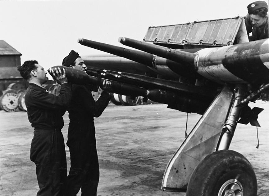 RAF armourers loading RP-3 rockets with 60 lb warheads onto the underwing rails of a Hawker Typhoon