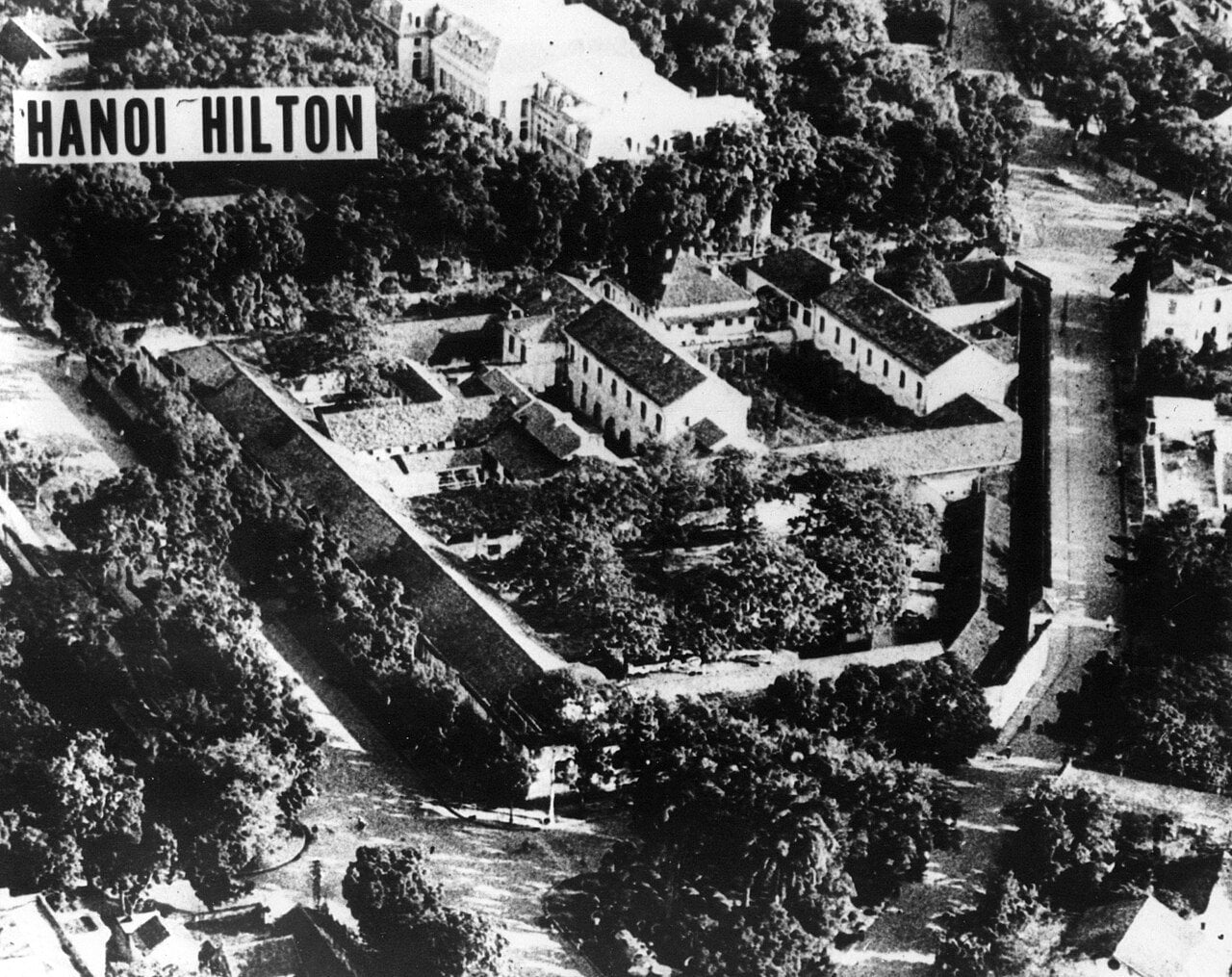 1970 aerial photograph of Hoa Lo prison, labelled Hanoi Hilton, surrounded by trees in central Hanoi