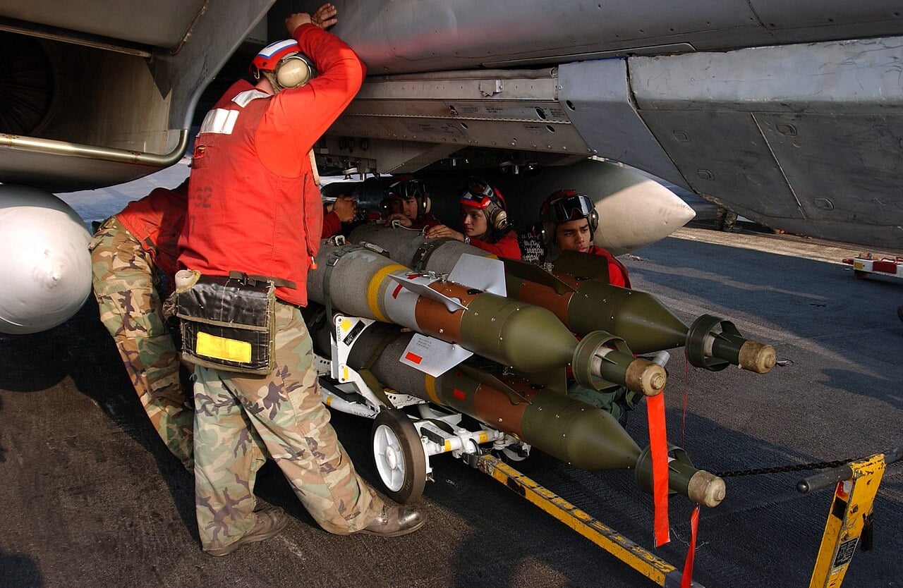 U.S. Navy ordnancemen loading GBU-12 Paveway II laser-guided bombs onto an F-14B Tomcat aboard USS Harry S. Truman in 2004