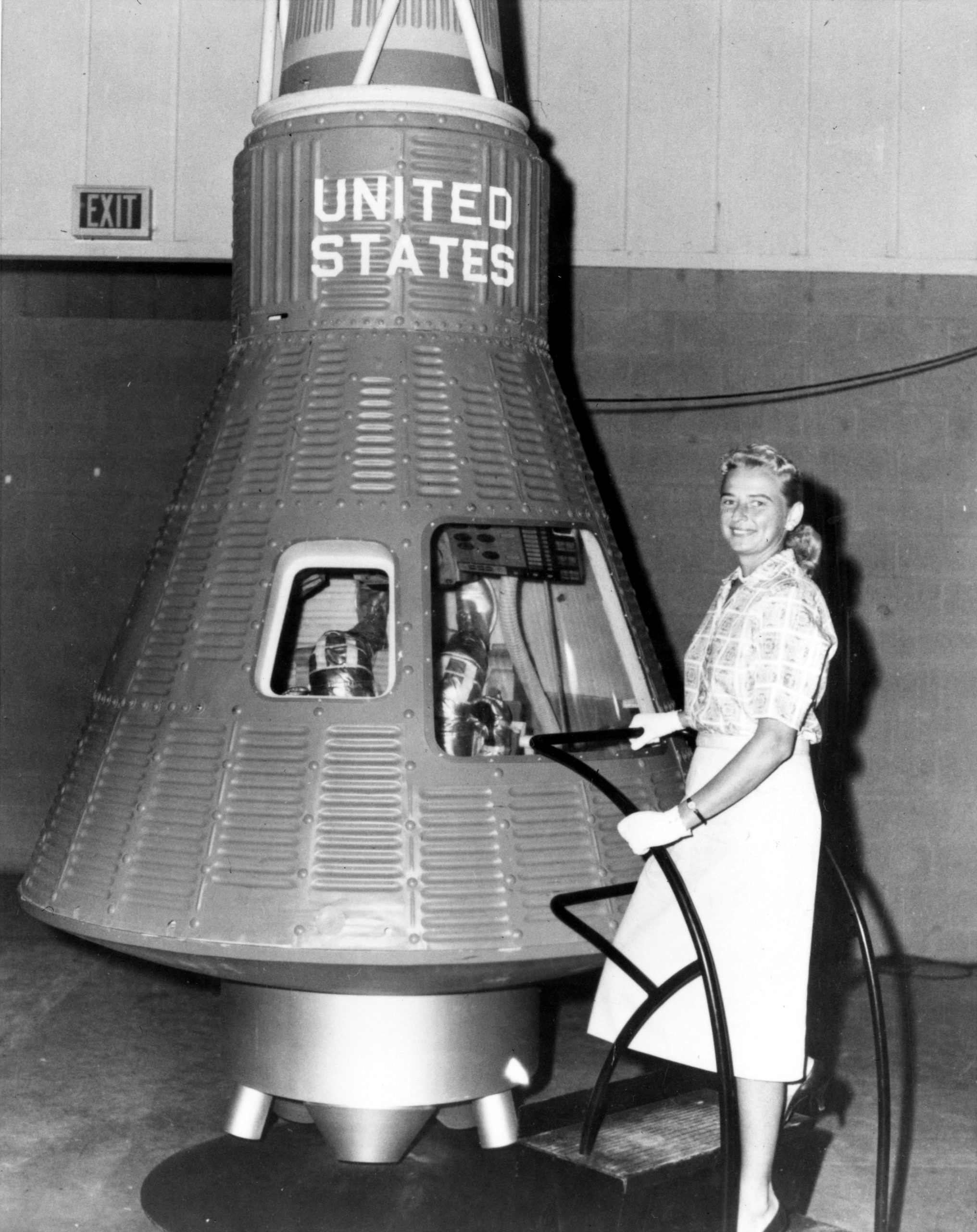 Jerrie Cobb beside a Mercury capsule