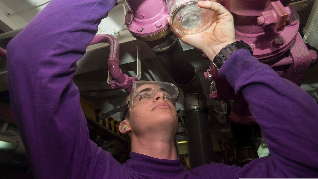 JP-5 jet fuel sample aboard USS Harry S. Truman A US Navy fuels specialist holding up a sample of JP-5 jet fuel aboard an aircraft carrier