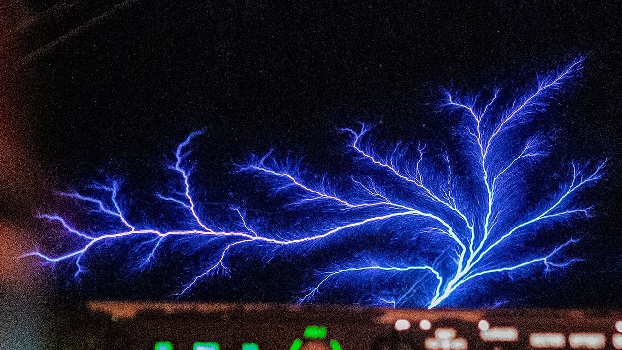 Branching violet and blue St Elmo&rsquo;s fire discharge across the windshield of a US Air Force KC-135 Stratotanker at night
