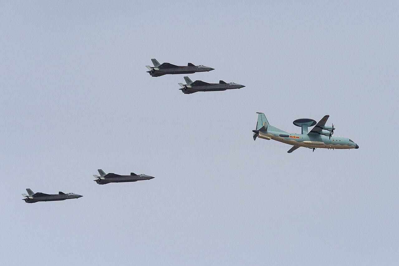 KJ-500 airborne early warning aircraft flying with four J-20 stealth fighters