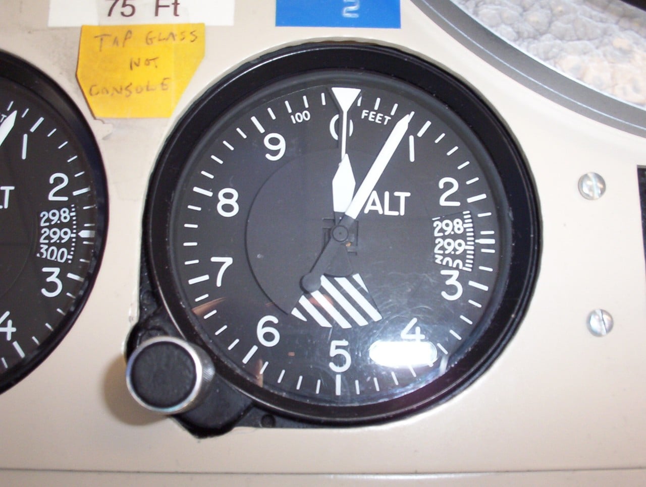 Barometric altimeter dial reading about 75 feet with 29.87 inches of mercury in the Kollsman window
