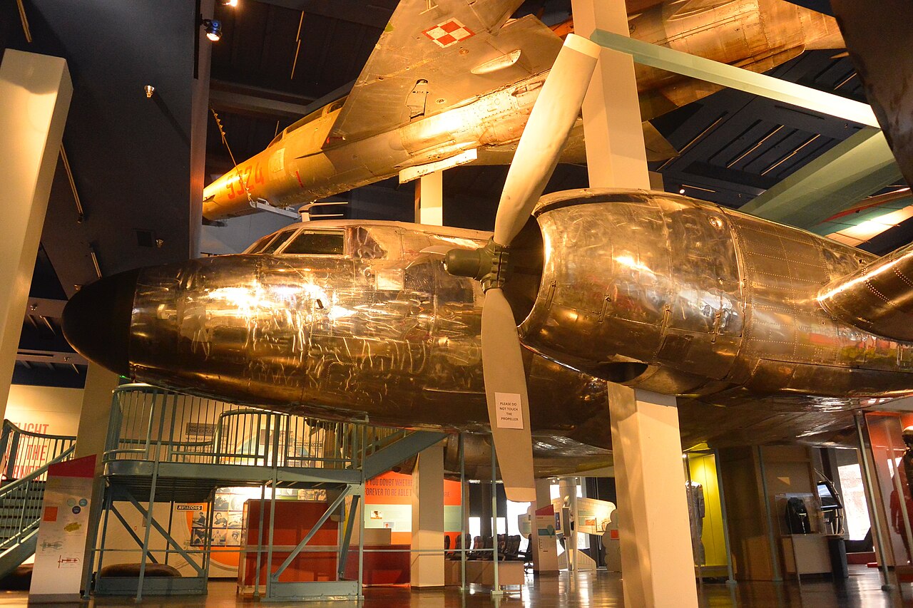 Former Polish Air Force MiG-21 suspended above a polished Convair C-131 Samaritan in The Leonardo FLIGHT exhibit, Salt Lake City