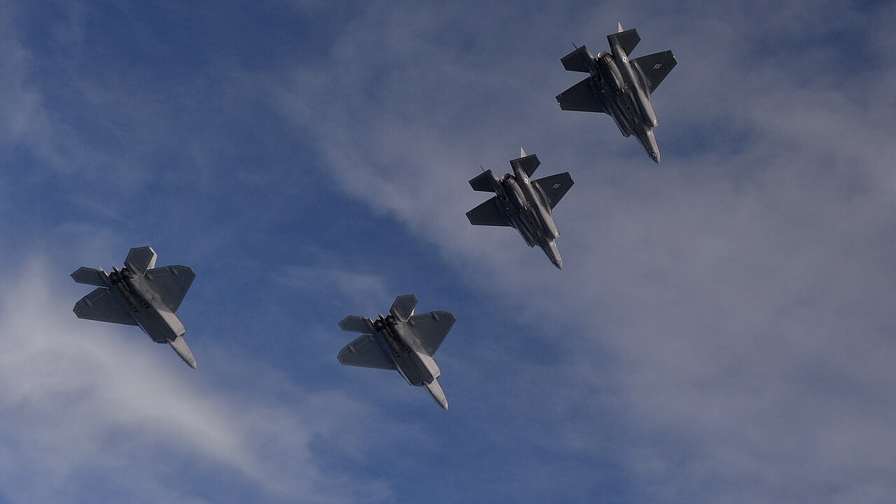 Two US Air Force F-22 Raptors and two F-35A Lightning IIs flying in formation over the Eglin range in Florida