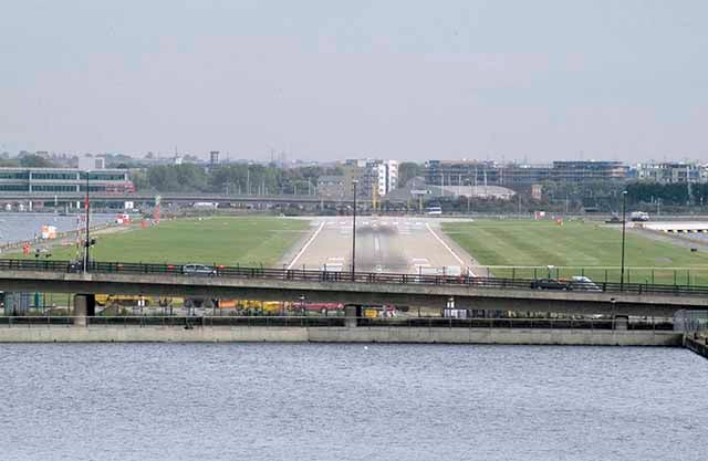 London City Airport runway seen head on from the west across the Royal Docks