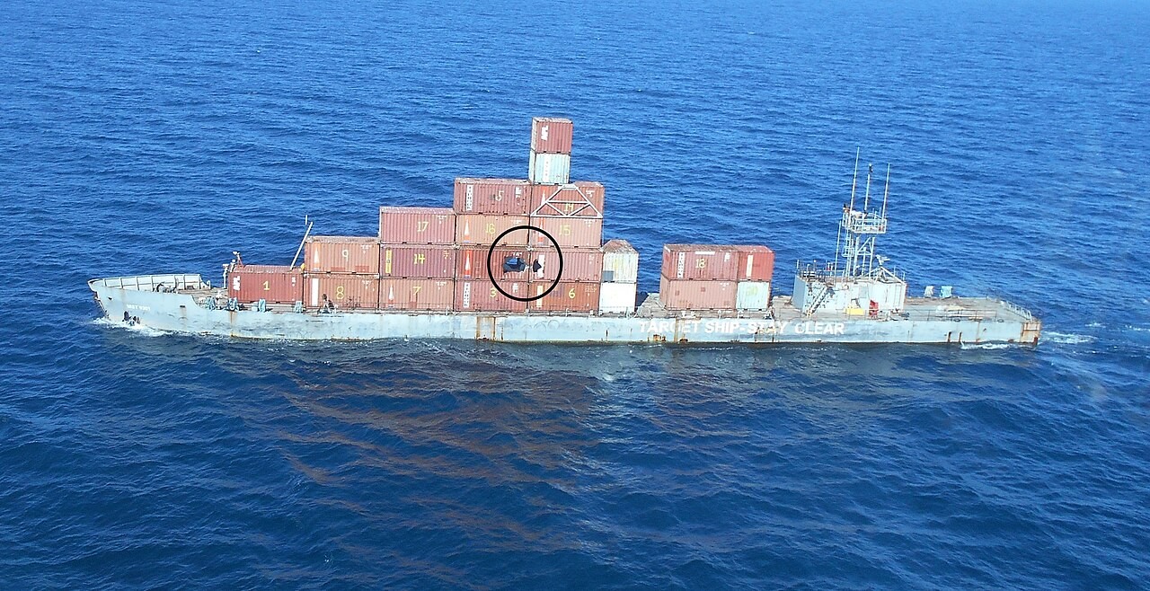 The 260-foot Mobile Ship Target after an LRASM prototype strike, with the impact point circled on its container stack