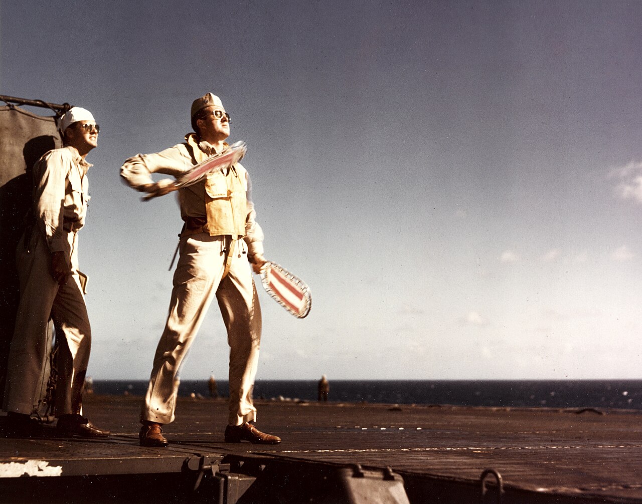 Landing signal officer aboard USS Lexington signals cut in 1943