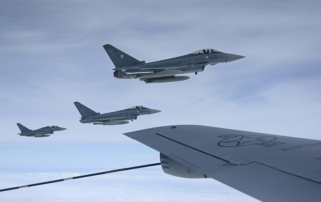 Three German Air Force Eurofighter Typhoons of Tactical Air Wing 71 flying in formation behind a tanker over Germany