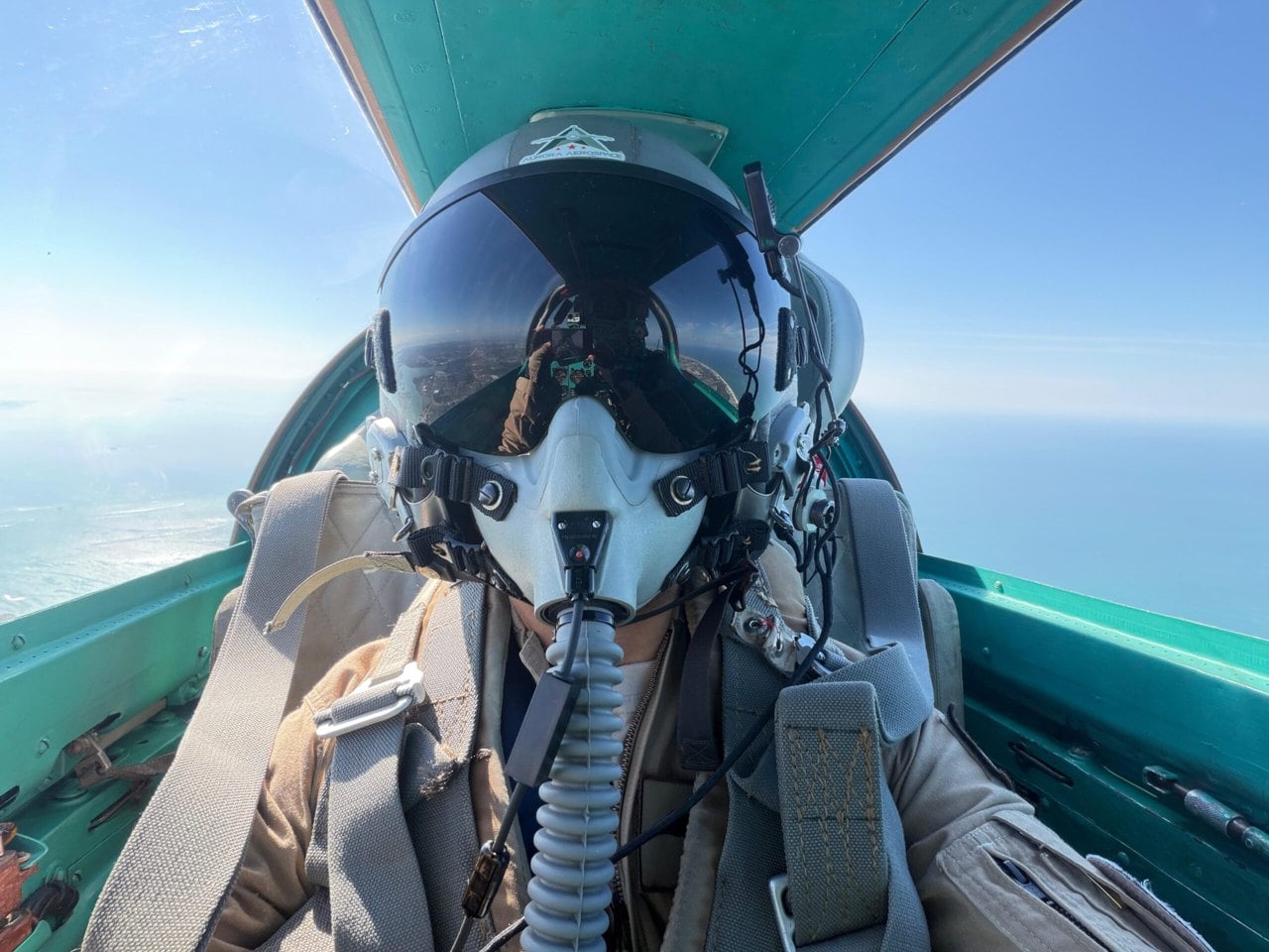 MiGFlug customer in the cockpit of a MiG-21 over the sea