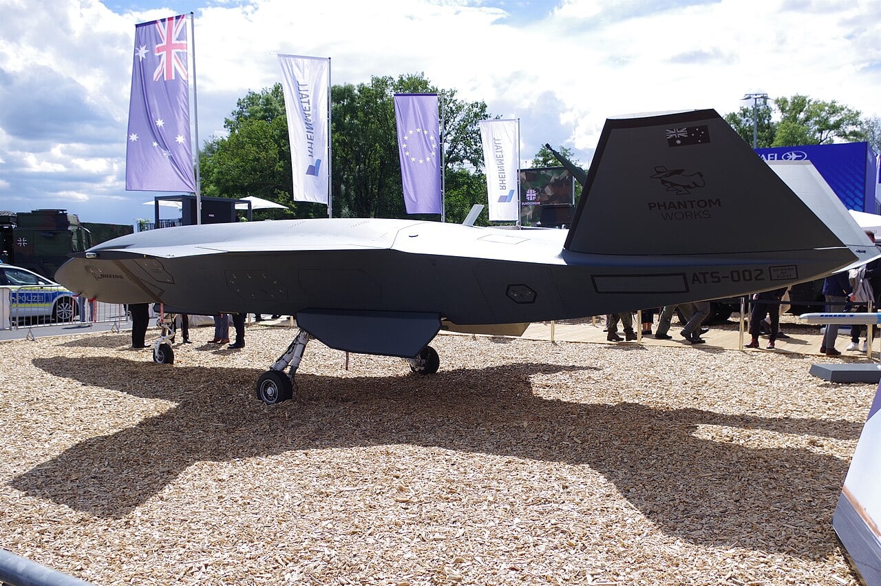 Boeing MQ-28 Ghost Bat ATS-002 with Australian flag on its tail displayed at ILA Berlin 2026 beside Rheinmetall banners