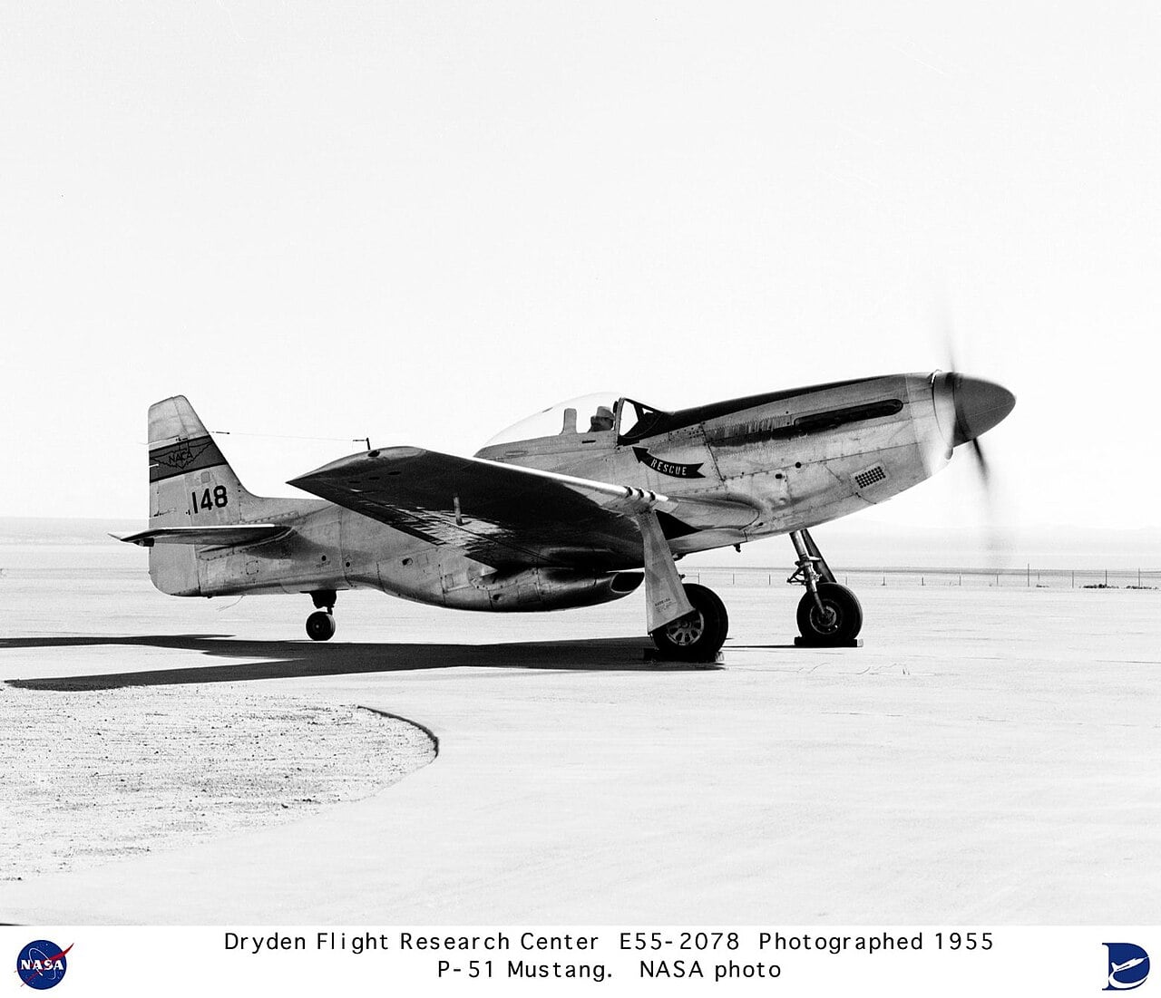 A NACA F-51 Mustang running up its engine on the taxiway beside Rogers Dry Lake in 1955, sitting nose-high on its tailwheel