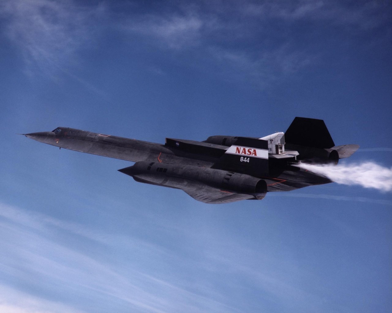NASA 844 SR-71 in flight with the Linear Aerospike SR-71 Experiment pod on its back, venting water during a cold-flow test