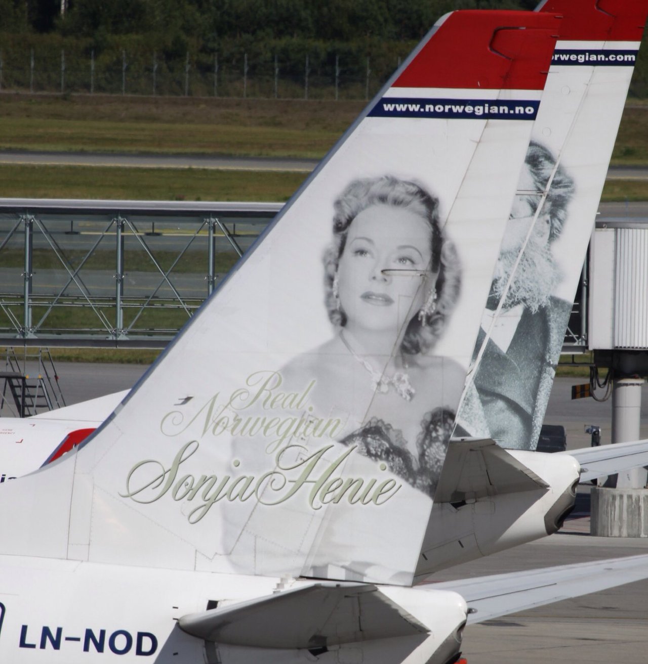 Tail fin of Norwegian Boeing 737-800 LN-NOD with a portrait of Sonja Henie and the words Real Norwegian