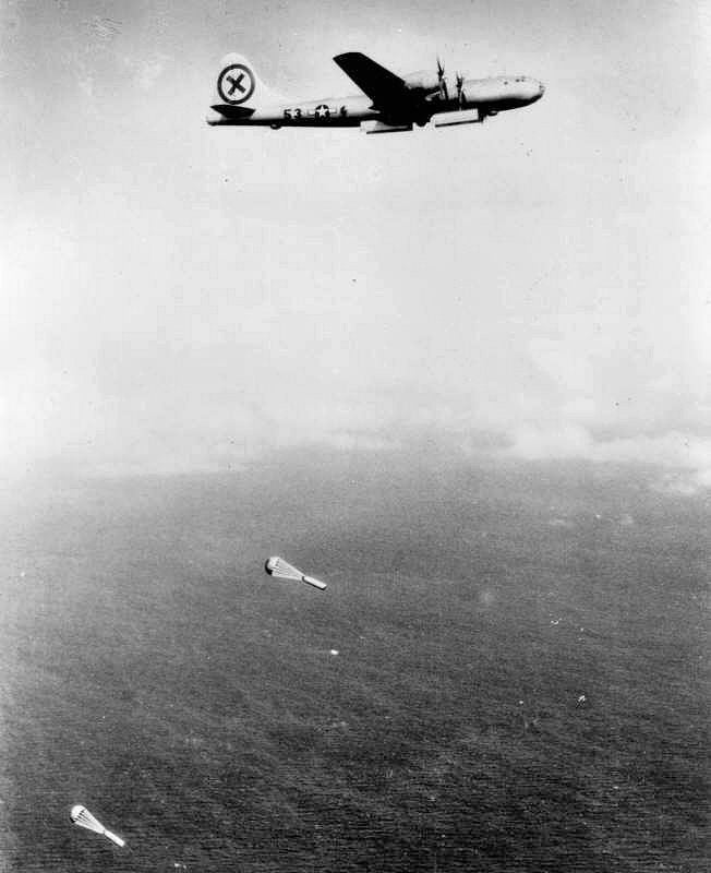 B-29 Superfortress of the 9th Bomb Group dropping two parachute-retarded aerial mines over the sea