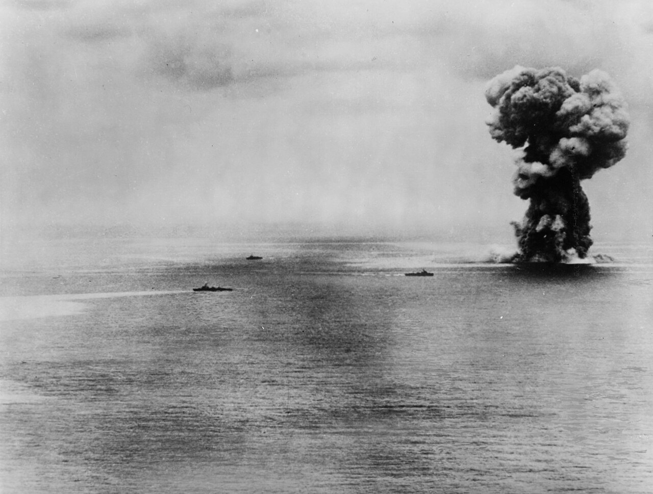 Smoke rising from the explosion of the battleship Yamato on 7 April 1945, with Japanese destroyers nearby