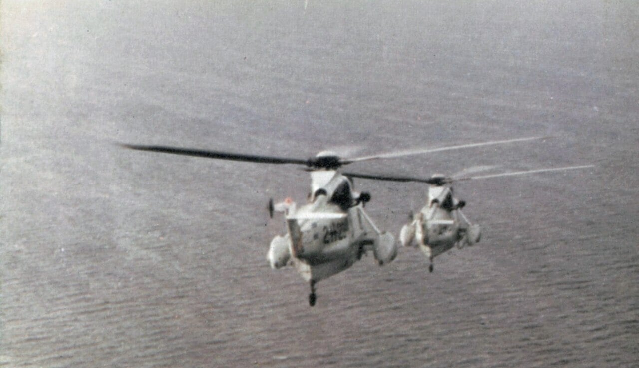 Two Argentine Navy Sea King helicopters flying low over the sea
