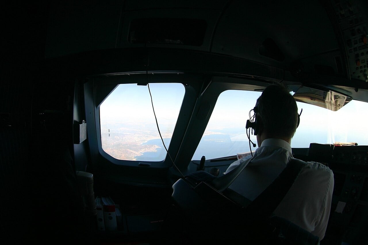 An airline captain looks out of the cockpit window of an Airbus A320 family aircraft during the descent towards Nice