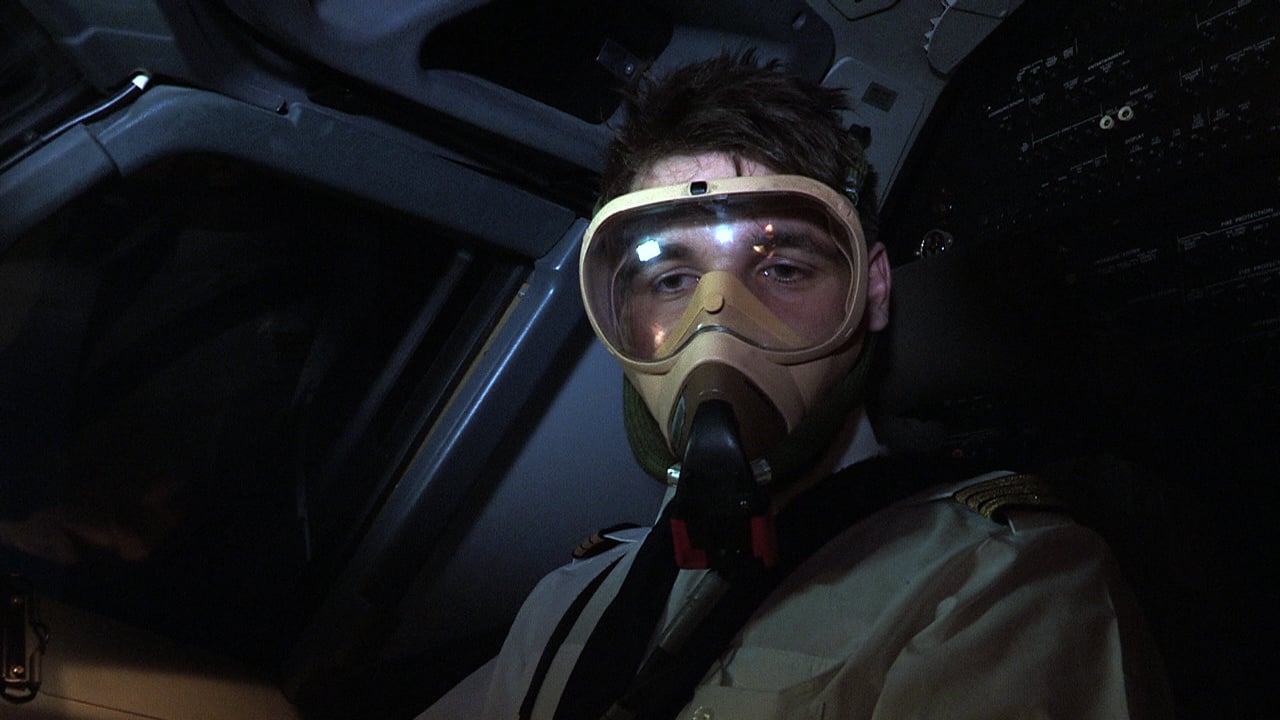 Pilot wearing a full-face oxygen mask in an airliner cockpit