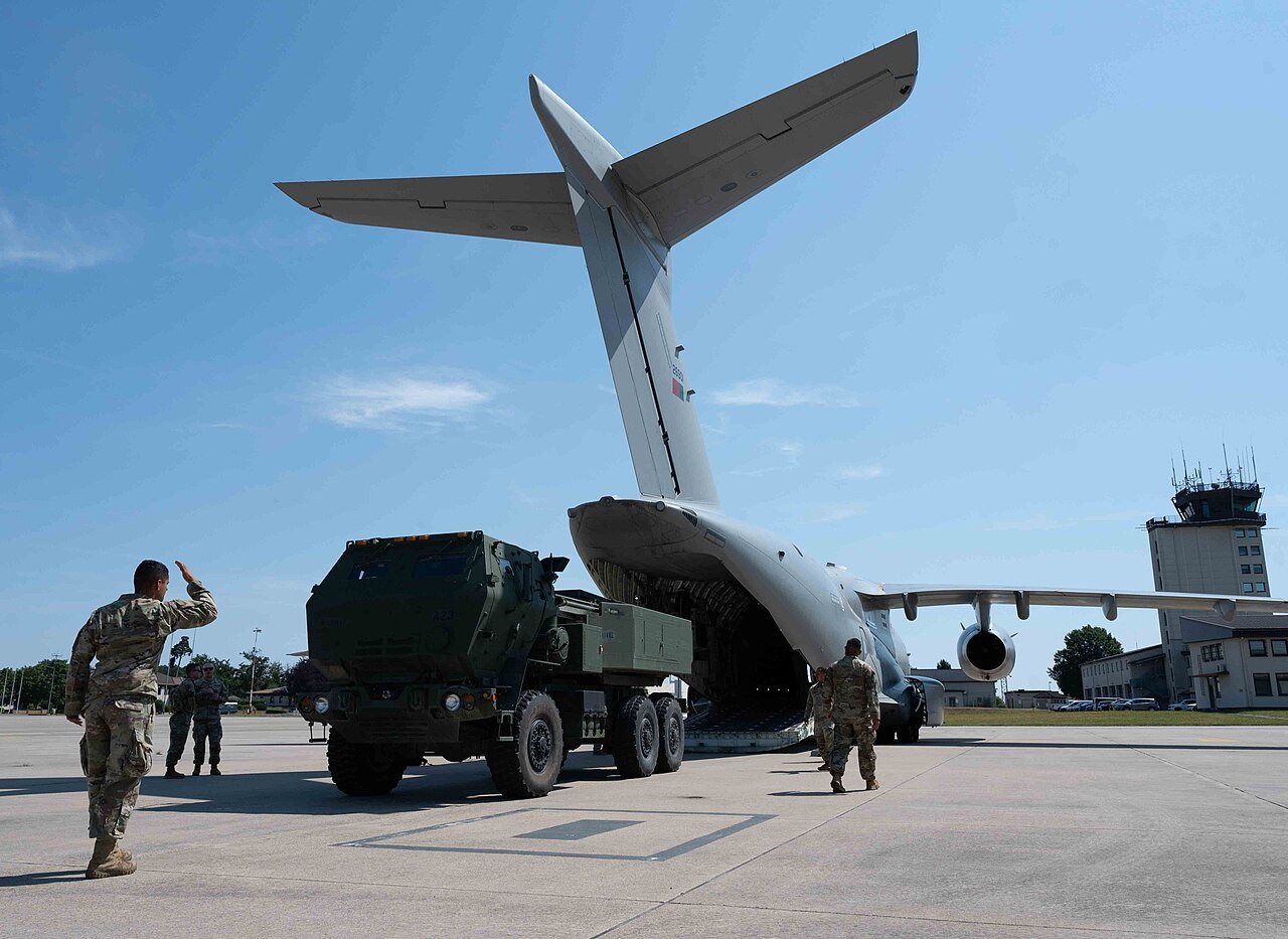 US and Portuguese personnel guide an M142 HIMARS down the rear ramp of a Portuguese Air Force KC-390 Millennium at Ramstein Air Base