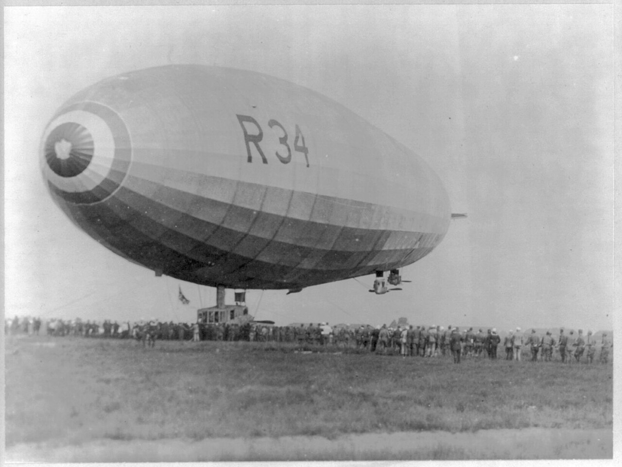 British airship R34 landing at Mineola, Long Island, in July 1919 with crowds on the field