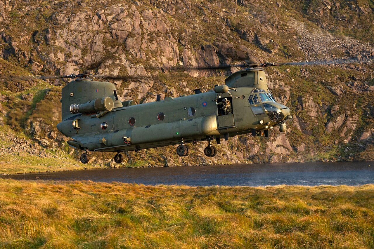 RAF Chinook in the Mountain Flying Training Area, Wales An RAF Chinook helicopter hovering low over rough moorland and a lake in the mountains of North Wales