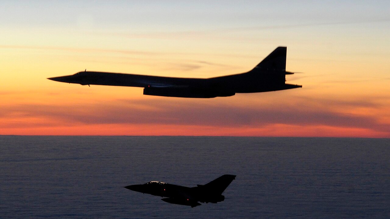An RAF Tornado F3 on Quick Reaction Alert shadows a Russian Tu-160 Blackjack bomber at sunset