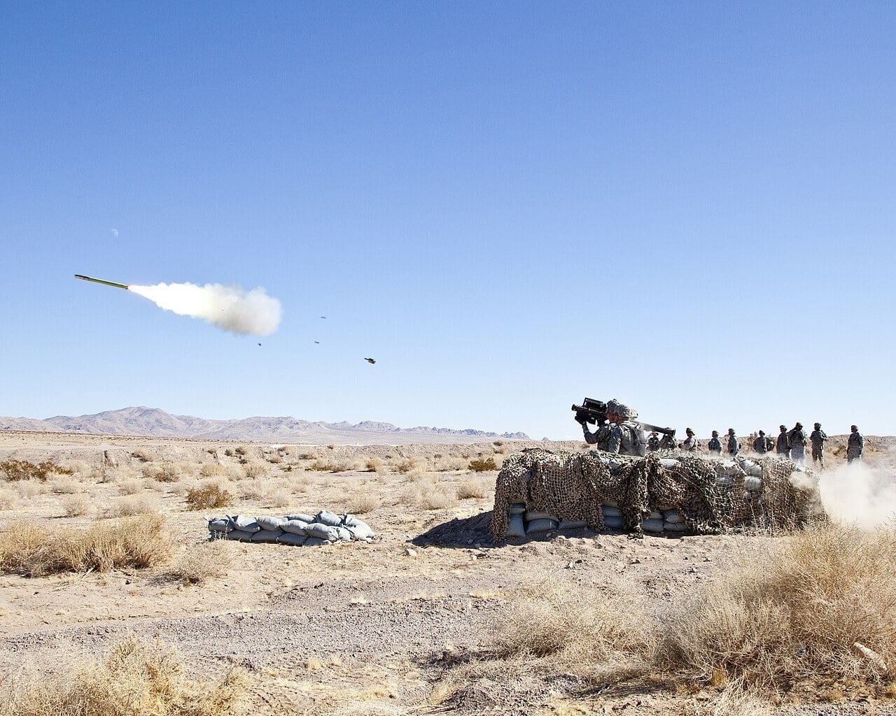 A US Army soldier fires an FIM-92 Stinger shoulder-launched surface-to-air missile at a target drone in the desert